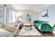 Cozy living room features a comfortable seating arrangement and large windows at 6365 Xavier Ct, Arvada, CO 80003