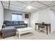Comfortable living room with a gray sofa, white coffee table, and a desk for work or study at 6365 Xavier Ct, Arvada, CO 80003