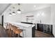 Stylish bar area with modern lighting, open shelves, and beverage refrigerator at 46692 Silver Fir St, Parker, CO 80138