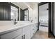 Stylish bathroom featuring a double sink vanity, modern lighting, and sleek hardware at 46692 Silver Fir St, Parker, CO 80138