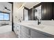 Bright bathroom with a double sink vanity, neutral countertops, and modern hardware at 46692 Silver Fir St, Parker, CO 80138