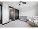 Well-lit Bedroom featuring a crib, sliding closet doors, and chair at 46692 Silver Fir St, Parker, CO 80138