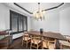 Elegant dining room with a large table, modern lighting, and a refined aesthetic at 46692 Silver Fir St, Parker, CO 80138