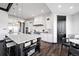 Bright kitchen features a large island with a marble countertop, wooden floors and stylish modern finishes at 46692 Silver Fir St, Parker, CO 80138