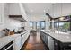 Gourmet kitchen featuring white cabinetry, stainless steel appliances, and a seamless open layout at 46692 Silver Fir St, Parker, CO 80138