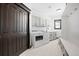 Well-organized laundry room with gray cabinets, modern appliances, and ample storage at 46692 Silver Fir St, Parker, CO 80138