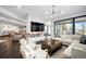 Bright and airy living room with large windows, modern furnishings, and fireplace at 46692 Silver Fir St, Parker, CO 80138