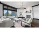 Living room with a fireplace, comfortable seating, and beautiful hardwood floors, perfect for relaxation at 46692 Silver Fir St, Parker, CO 80138