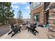 Outdoor patio area with stone fire pit and Adirondack chairs at 46692 Silver Fir St, Parker, CO 80138