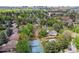 Aerial view of neighborhood showcasing homes with tennis court, pool, and lush landscaping at 6488 S Heritage E Pl, Centennial, CO 80111