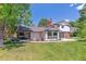 A well-maintained backyard with lush green grass, a patio, and a view of the home's exterior at 6488 S Heritage E Pl, Centennial, CO 80111