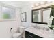 Charming bathroom with marble countertop, black vanity, and window for natural light at 6488 S Heritage E Pl, Centennial, CO 80111