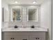 Contemporary bathroom featuring a double sink vanity with backlit mirrors and ample lighting at 6488 S Heritage E Pl, Centennial, CO 80111