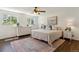 Serene bedroom with a large bed, patterned rug, and natural light streaming through the windows at 6488 S Heritage E Pl, Centennial, CO 80111