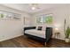 Bright bedroom featuring hardwood floors, two windows, and a modern daybed at 6488 S Heritage E Pl, Centennial, CO 80111