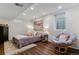 Comfortable bedroom with a cozy chair, large painting, and hardwood floors at 6488 S Heritage E Pl, Centennial, CO 80111
