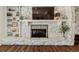 Close up of the stone fireplace featuring shelving and modern décor at 6488 S Heritage E Pl, Centennial, CO 80111