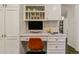 Bright, modern home office area features custom cabinets, drawers, desktop, and decorative tile backsplash at 6488 S Heritage E Pl, Centennial, CO 80111