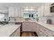 Well-lit kitchen featuring white cabinetry, quartz countertops, and modern fixtures at 6488 S Heritage E Pl, Centennial, CO 80111