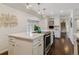 Updated kitchen with white cabinets, an island, and stainless steel appliances at 6488 S Heritage E Pl, Centennial, CO 80111