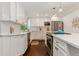 Contemporary kitchen featuring an island, updated appliances, and ample counter space at 6488 S Heritage E Pl, Centennial, CO 80111