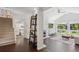 Bright living room with stone fireplace, vaulted ceiling, and large windows offering verdant views at 6488 S Heritage E Pl, Centennial, CO 80111