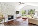 Cozy living room features a stone fireplace, wood floors, and large windows showcasing the backyard at 6488 S Heritage E Pl, Centennial, CO 80111