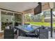 Covered patio with outdoor dining set and access to the green backyard and home interior at 6488 S Heritage E Pl, Centennial, CO 80111