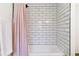 Subway tile shower featuring a pink shower curtain and white accents at 6488 S Heritage E Pl, Centennial, CO 80111