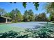 A well-maintained tennis court on a sunny day surrounded by lush greenery and mature trees at 6488 S Heritage E Pl, Centennial, CO 80111