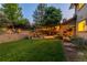 Backyard view showcases an outdoor seating area with landscaping, lighting, and a pergola at 8291 S Krameria Way, Centennial, CO 80112