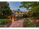 Beautiful backyard with stone pathway to pergola, patio, and fire pit with lovely landscaping at 8291 S Krameria Way, Centennial, CO 80112
