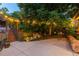 Relaxing backyard patio with landscape waterfall feature and mature trees with decorative string lights at 8291 S Krameria Way, Centennial, CO 80112