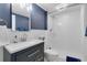 Modern bathroom with white subway tile shower and dark blue vanity, creating a fresh, clean feel at 8291 S Krameria Way, Centennial, CO 80112