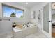This bright bathroom is equipped with a soaking tub, a separate shower, a heater rack, and an exterior window at 8291 S Krameria Way, Centennial, CO 80112