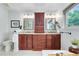 The bathroom is equipped with double vanities, framed mirrors, a tub, custom wood cabinets, and a separate toilet area at 8291 S Krameria Way, Centennial, CO 80112