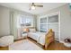 Cozy bedroom with wood frame bed, wood floors, a fluffy rug, and bright natural light at 8291 S Krameria Way, Centennial, CO 80112