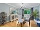 Elegant dining room featuring a glass table, chandelier, mirrored cabinet and large windows at 8291 S Krameria Way, Centennial, CO 80112