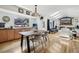 Open floor plan with a dining table with hardwood floors and a view to the living room with fireplace at 8291 S Krameria Way, Centennial, CO 80112