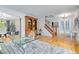 Open entryway with hardwood floors, a staircase, and a view of the adjacent dining room at 8291 S Krameria Way, Centennial, CO 80112