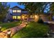 Well-maintained two-story home with lush front yard and stone pathway with landscape lighting at 8291 S Krameria Way, Centennial, CO 80112