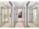 The hallway includes multiple mirrored closets, hardwood floors, and provides access to the adjacent full bathroom at 8291 S Krameria Way, Centennial, CO 80112