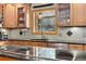 Detailed view of kitchen featuring granite countertops, wood cabinets, and stainless steel appliances at 8291 S Krameria Way, Centennial, CO 80112