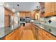Spacious kitchen with wood cabinets, granite countertops, stainless steel appliances, and hardwood floors at 8291 S Krameria Way, Centennial, CO 80112