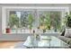 Bright living room with large windows offering views of the surrounding greenery and sunlight at 8291 S Krameria Way, Centennial, CO 80112