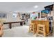 Basement living room featuring a bar, a shuffleboard table, and ample wall decor at 8291 S Krameria Way, Centennial, CO 80112