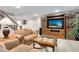 Basement living room features a large tv, wood shelving, a coffee table, and comfortable seating at 8291 S Krameria Way, Centennial, CO 80112