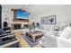 Sun-filled living room features a stone fireplace, hardwood floors and comfortable seating arrangements at 8291 S Krameria Way, Centennial, CO 80112