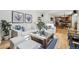 Cozy living room with hardwood floors, comfortable seating, and access to the kitchen and dining area at 8291 S Krameria Way, Centennial, CO 80112