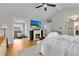 A cozy main bedroom includes a fireplace, television, plush rug, adjoining walk-in closet, and an ensuite bathroom at 8291 S Krameria Way, Centennial, CO 80112